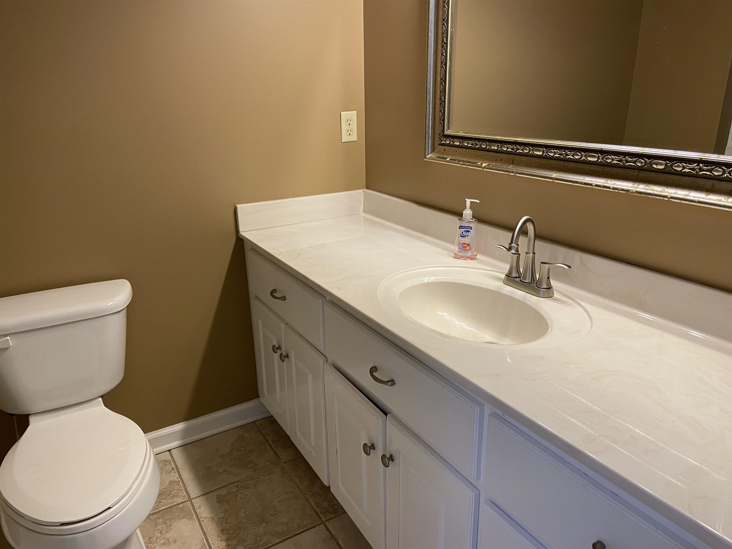 610 Old Finger Road Henderson, TN 38340 - Photo 8 of 24 a bathroom with a granite countertop toilet sink and mirror