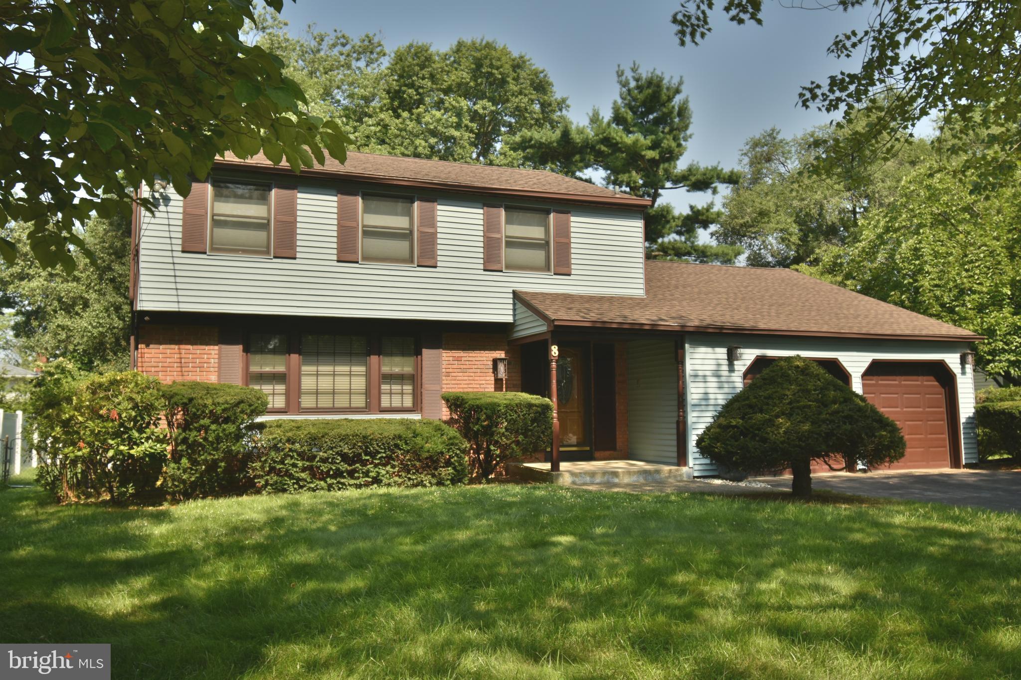 a view of a house with a garden and plants
