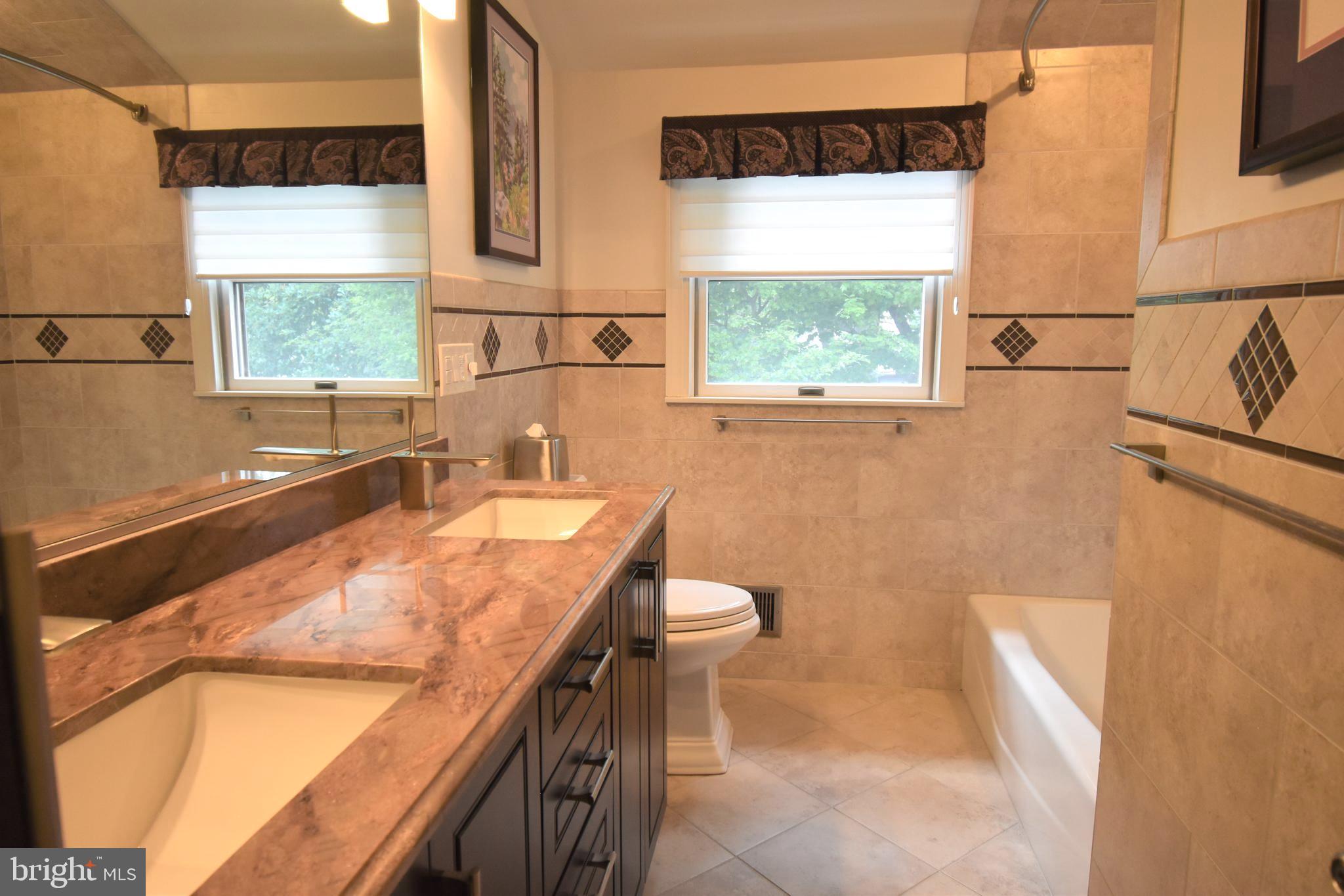 8 Forge Lane Cherry Hill, NJ 08002 - Photo 21 of 23 a bathroom with a granite countertop sink a mirror and a bathtub