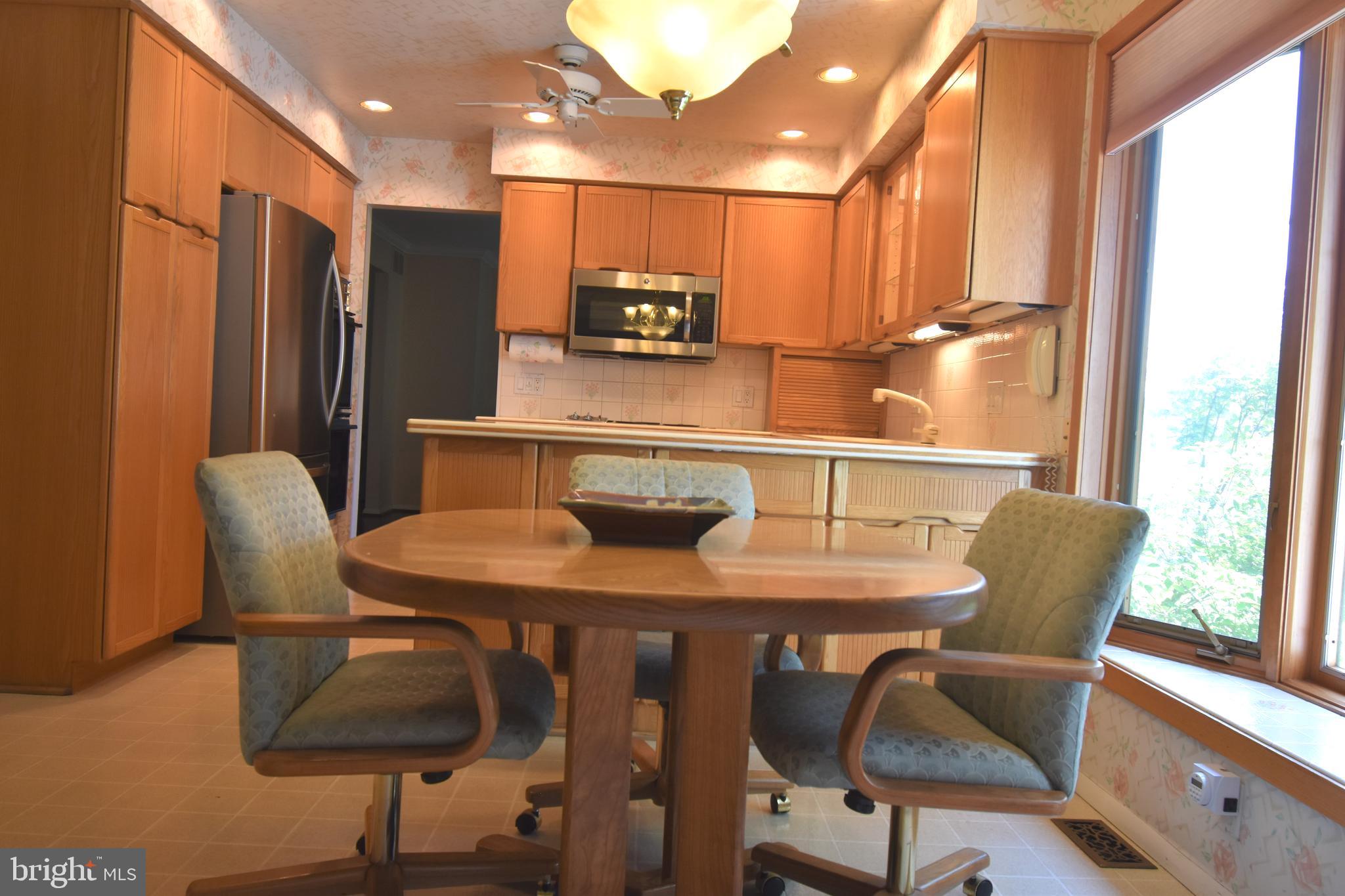 8 Forge Lane Cherry Hill, NJ 08002 - Photo 9 of 23 a kitchen with stainless steel appliances granite countertop a table chairs and a refrigerator