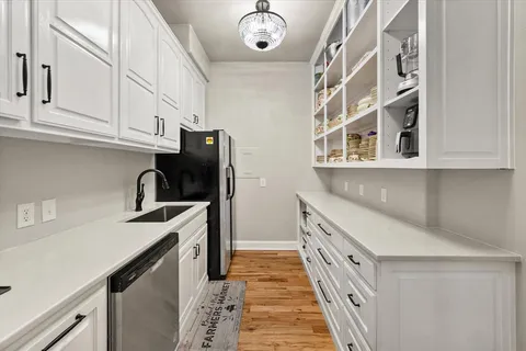 a bathroom with a granite countertop sink with a painting on the wall