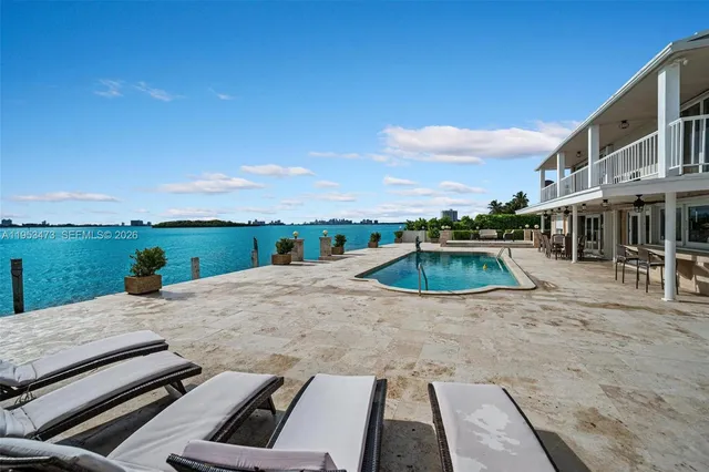 a view of a swimming pool with an outdoor seating