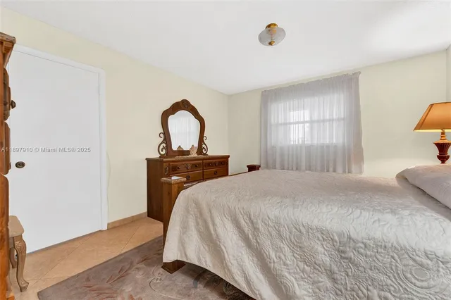 a bedroom with a bed and a sink