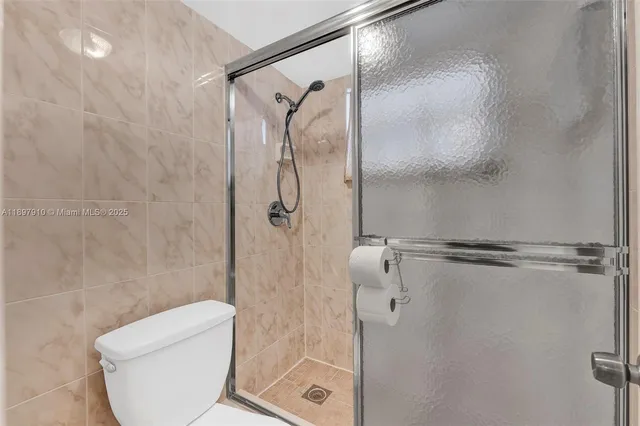 a bathroom with a shower and toilet