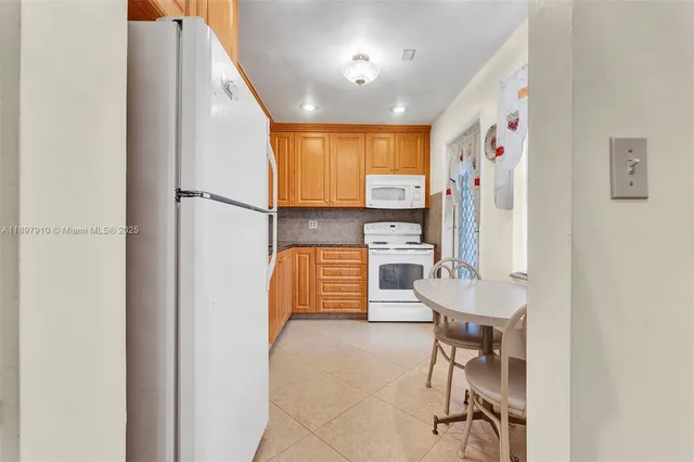a view of kitchen with furniture and a refrigerator