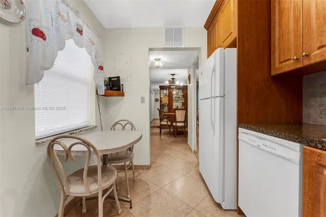 a kitchen with refrigerator and cabinets