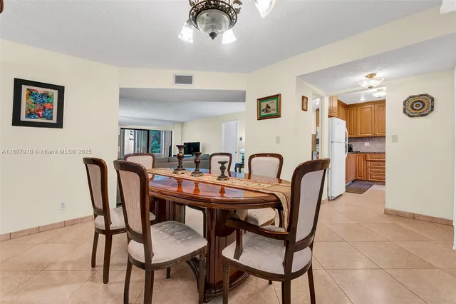 a view of a a dining room with furniture window and wooden floor