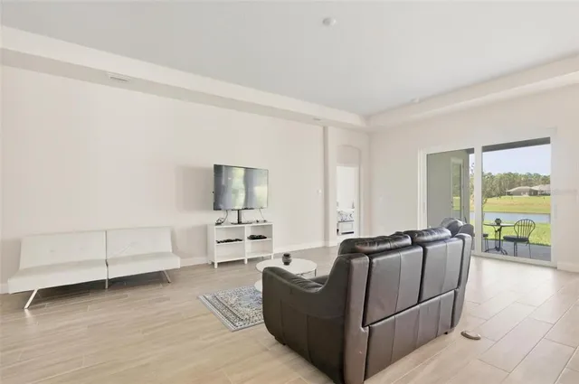 a living room with furniture and large windows