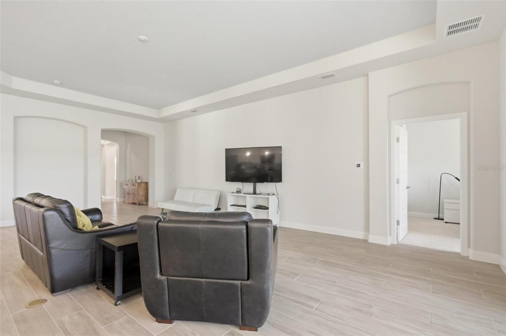 21 Spring Street Palm Coast, FL 32164 - Photo 13 of 57 a living room with furniture and a flat screen tv