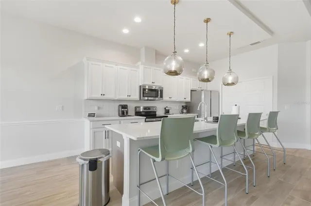 a view of dining room and kitchen with furniture wooden floor and window