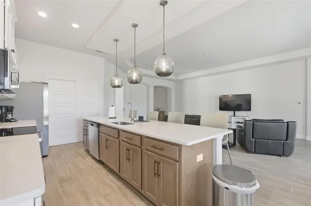 a large kitchen with a table and chairs