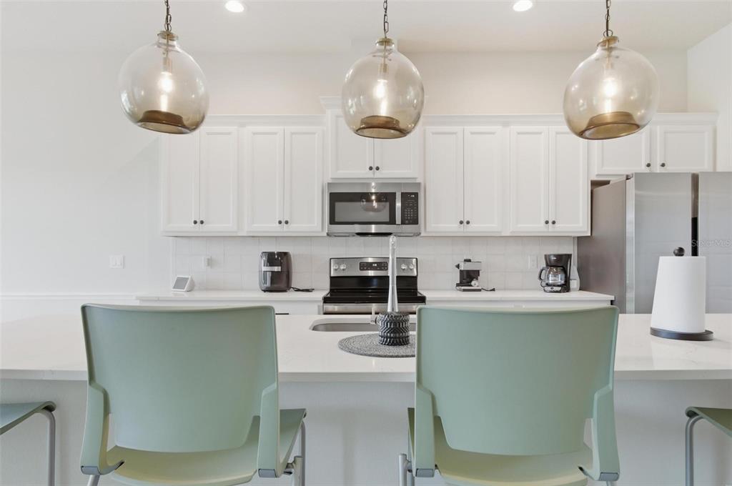 21 Spring Street Palm Coast, FL 32164 - Photo 16 of 57 a kitchen with stainless steel appliances granite countertop a stove a sink and a refrigerator