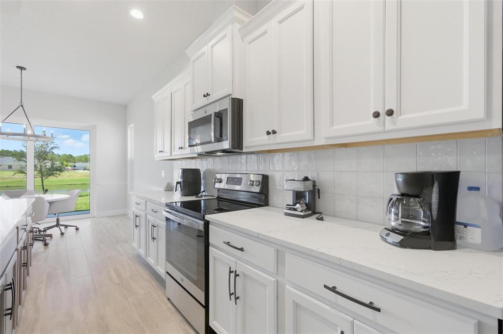 21 Spring Street Palm Coast, FL 32164 - Photo 18 of 57 a kitchen with stainless steel appliances granite countertop a sink a stove and cabinets