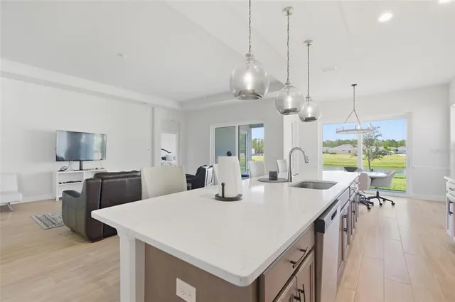 a dining room with furniture a chandelier and wooden floor
