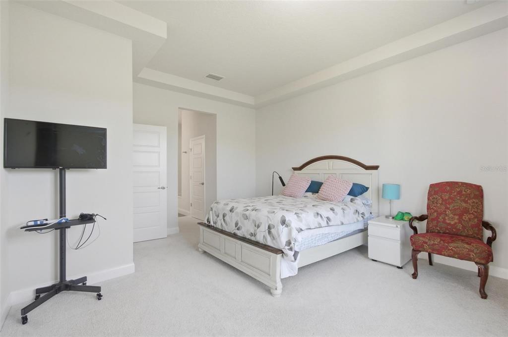 21 Spring Street Palm Coast, FL 32164 - Photo 31 of 57 a bedroom with a bed tv and a chair