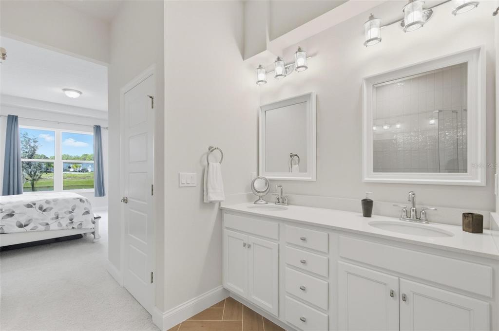 21 Spring Street Palm Coast, FL 32164 - Photo 37 of 57 a en suite bathroom with 2 sink tub and a mirror