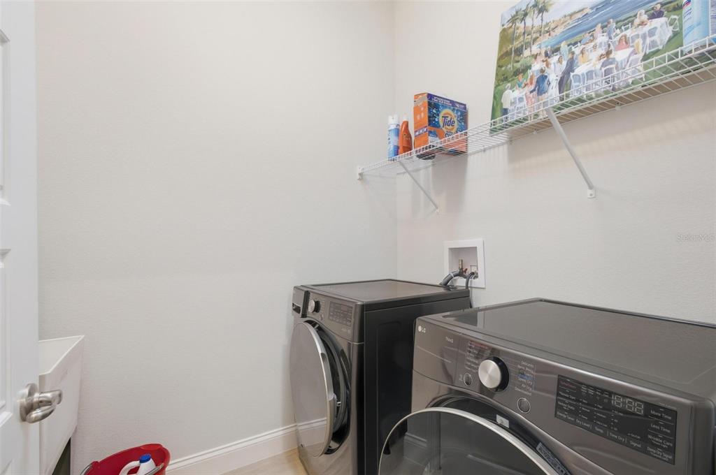 21 Spring Street Palm Coast, FL 32164 - Photo 43 of 57 a view of storage and utility room with racks on the wall