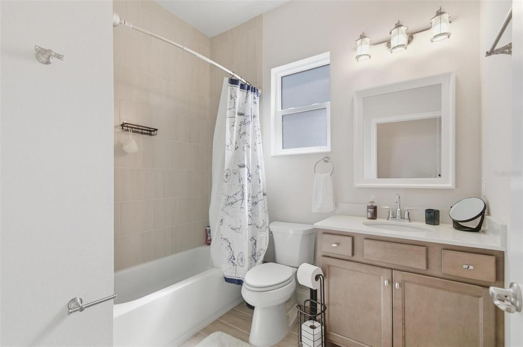 21 Spring Street Palm Coast, FL 32164 - Photo 47 of 57 a bathroom with a sink toilet tub vanity and shower