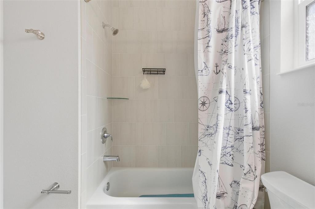 21 Spring Street Palm Coast, FL 32164 - Photo 48 of 57 a bathroom with a bathtub and shower