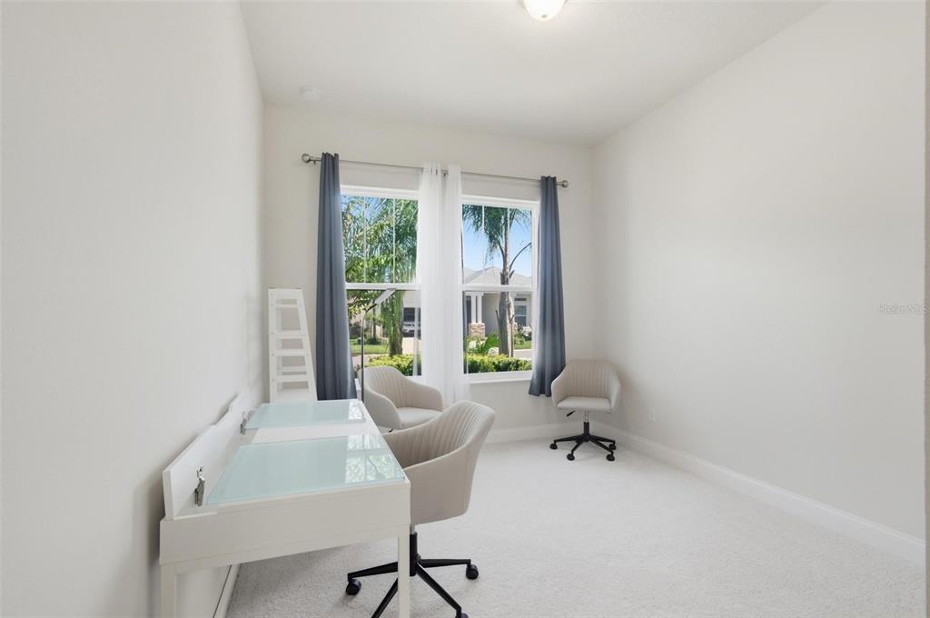 21 Spring Street Palm Coast, FL 32164 - Photo 50 of 57 a view of a workspace with furniture and a window
