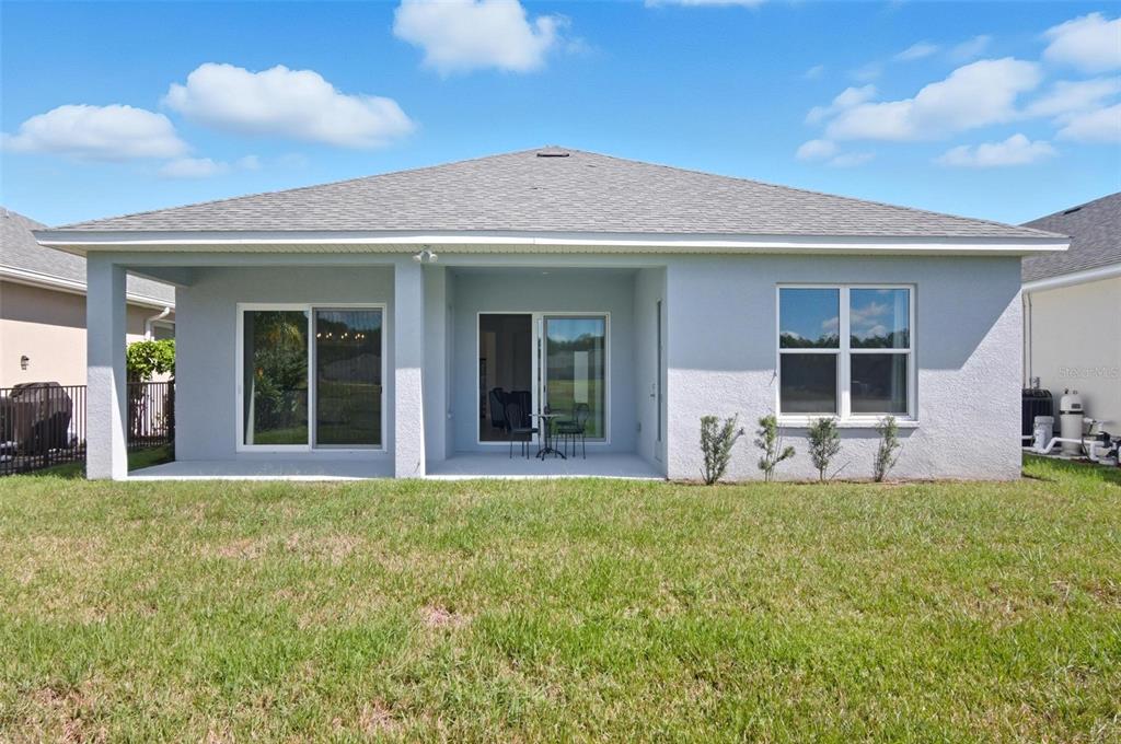 21 Spring Street Palm Coast, FL 32164 - Photo 56 of 57 a view of a house with sitting area and garden