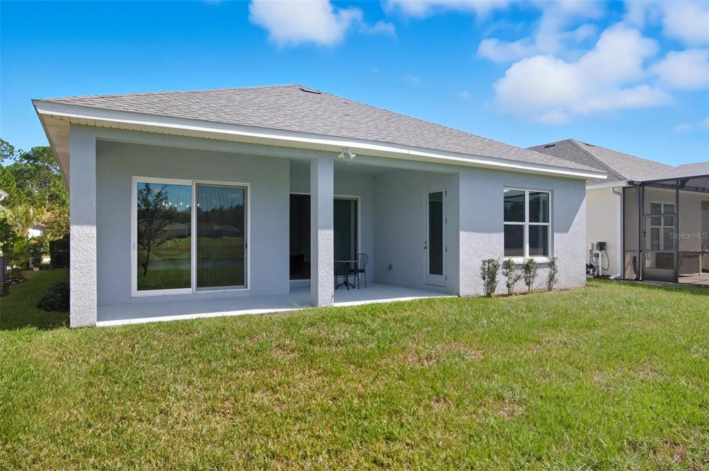 21 Spring Street Palm Coast, FL 32164 - Photo 57 of 57 a view of a house with backyard porch and garden