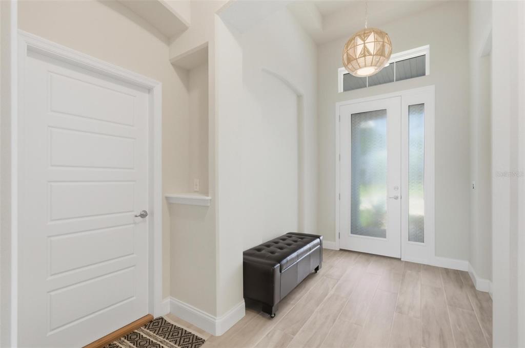21 Spring Street Palm Coast, FL 32164 - Photo 8 of 57 an empty room with wooden floor cabinet and hallway