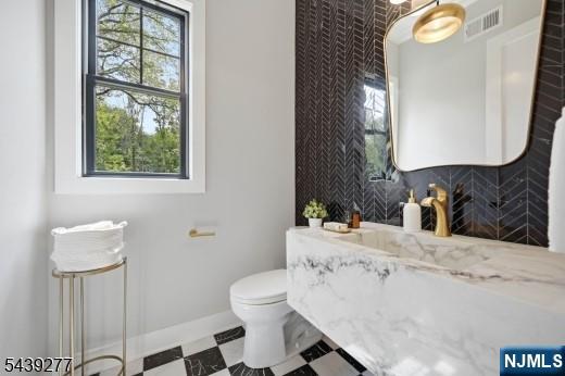 12 Locust Place Livingston, NJ 07039 - Photo 8 of 17 a bathroom with a sink toilet and mirror