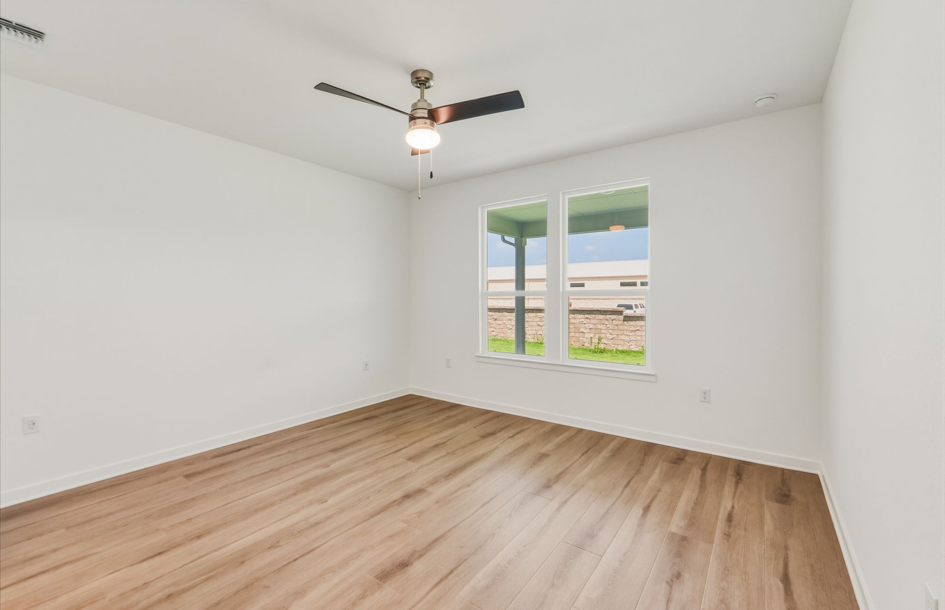 207 Smokestack Lane Georgetown, TX 78633 - Photo 9 of 21 wooden floor in an empty room with a window