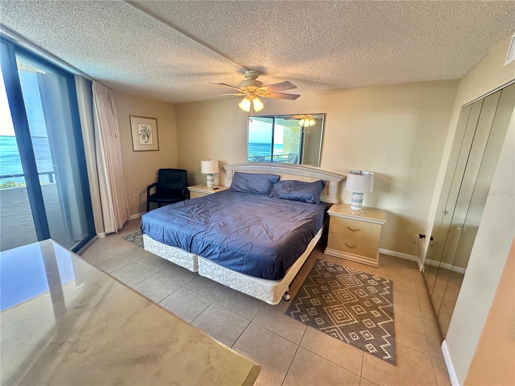 6009 Sea Ranch Drive, Unit 707 Hudson, FL 34667 - Photo 15 of 61 a bedroom with a large bed and a window