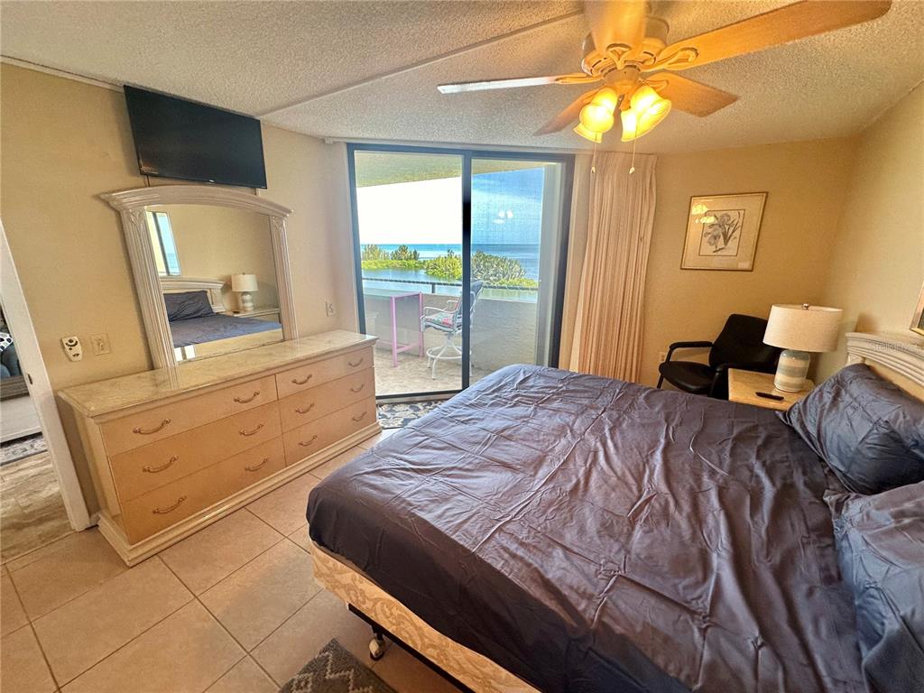6009 Sea Ranch Drive, Unit 707 Hudson, FL 34667 - Photo 16 of 61 a bedroom with a bed and a mirror on the dresser