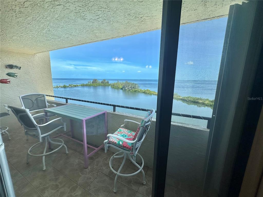 6009 Sea Ranch Drive, Unit 707 Hudson, FL 34667 - Photo 17 of 61 a balcony with chairs