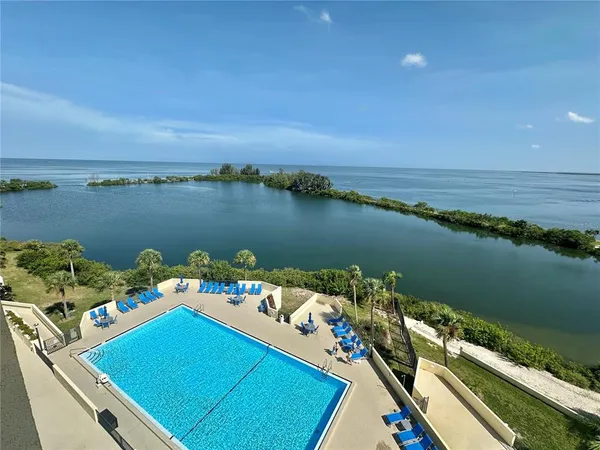 a view of a balcony with lake view and a floor to ceiling window