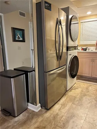 a bedroom with a bed and a mirror on the dresser