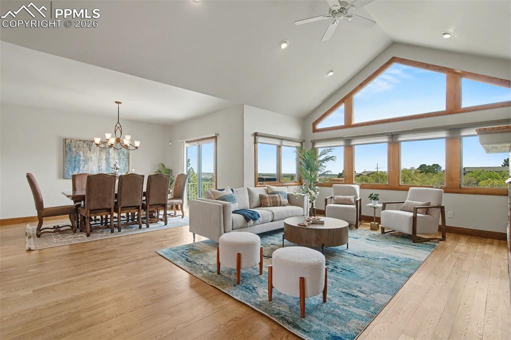 4215 Star Ranch Road Colorado Springs, CO 80906 - Photo 16 of 44 a living room with furniture and a chandelier