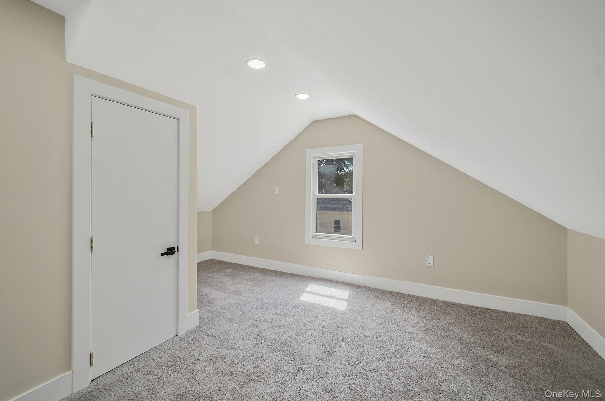 48 Vernon Street Patchogue, NY 11772 - Photo 18 of 31 Bonus room featuring carpet floors, lofted ceiling, and recessed lighting
