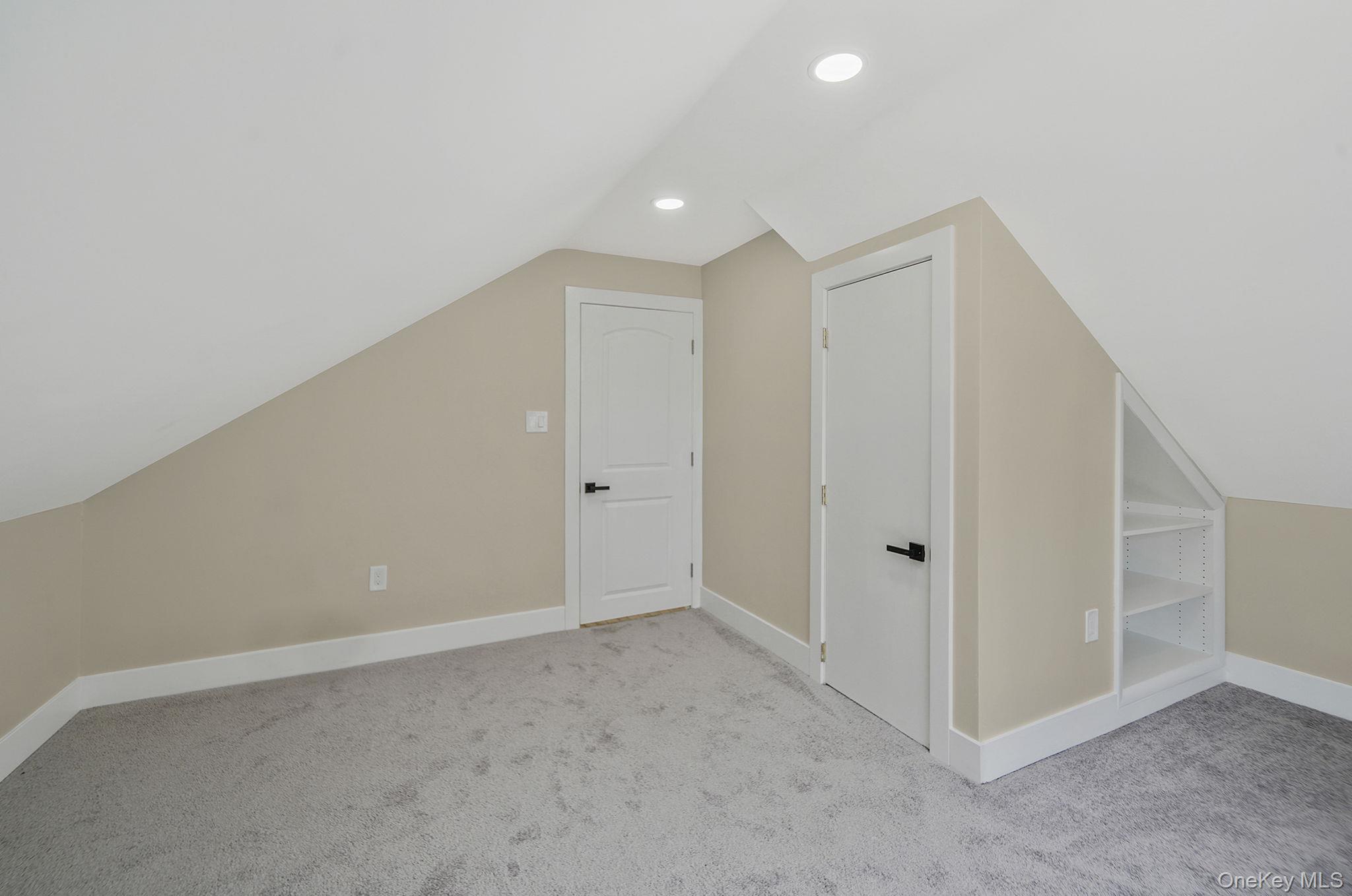 48 Vernon Street Patchogue, NY 11772 - Photo 19 of 31 Additional living space featuring vaulted ceiling, carpet, and recessed lighting