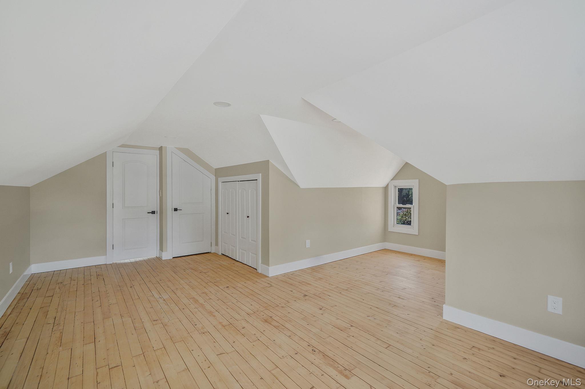48 Vernon Street Patchogue, NY 11772 - Photo 21 of 31 Additional living space featuring lofted ceiling and light wood-style flooring