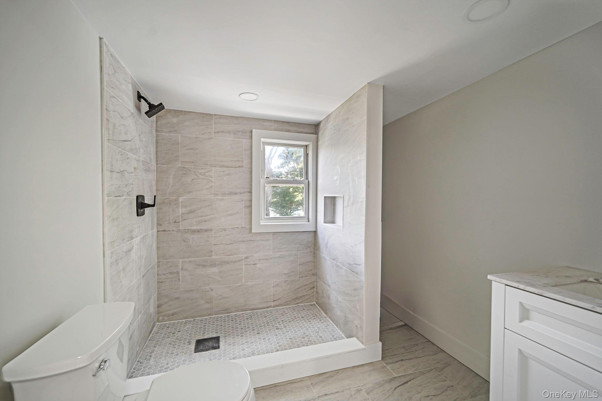 48 Vernon Street Patchogue, NY 11772 - Photo 22 of 31 Bathroom with vanity and a stall shower