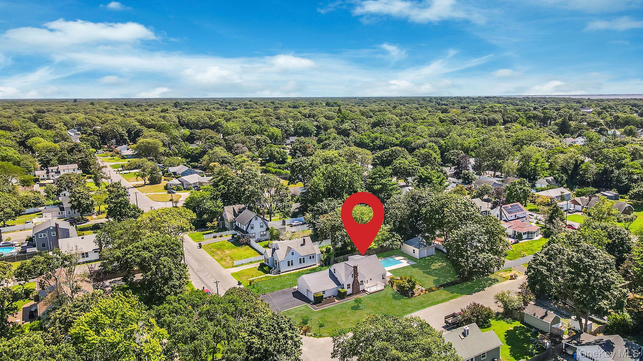 48 Vernon Street Patchogue, NY 11772 - Photo 29 of 31 Aerial view of residential area featuring a heavily wooded area