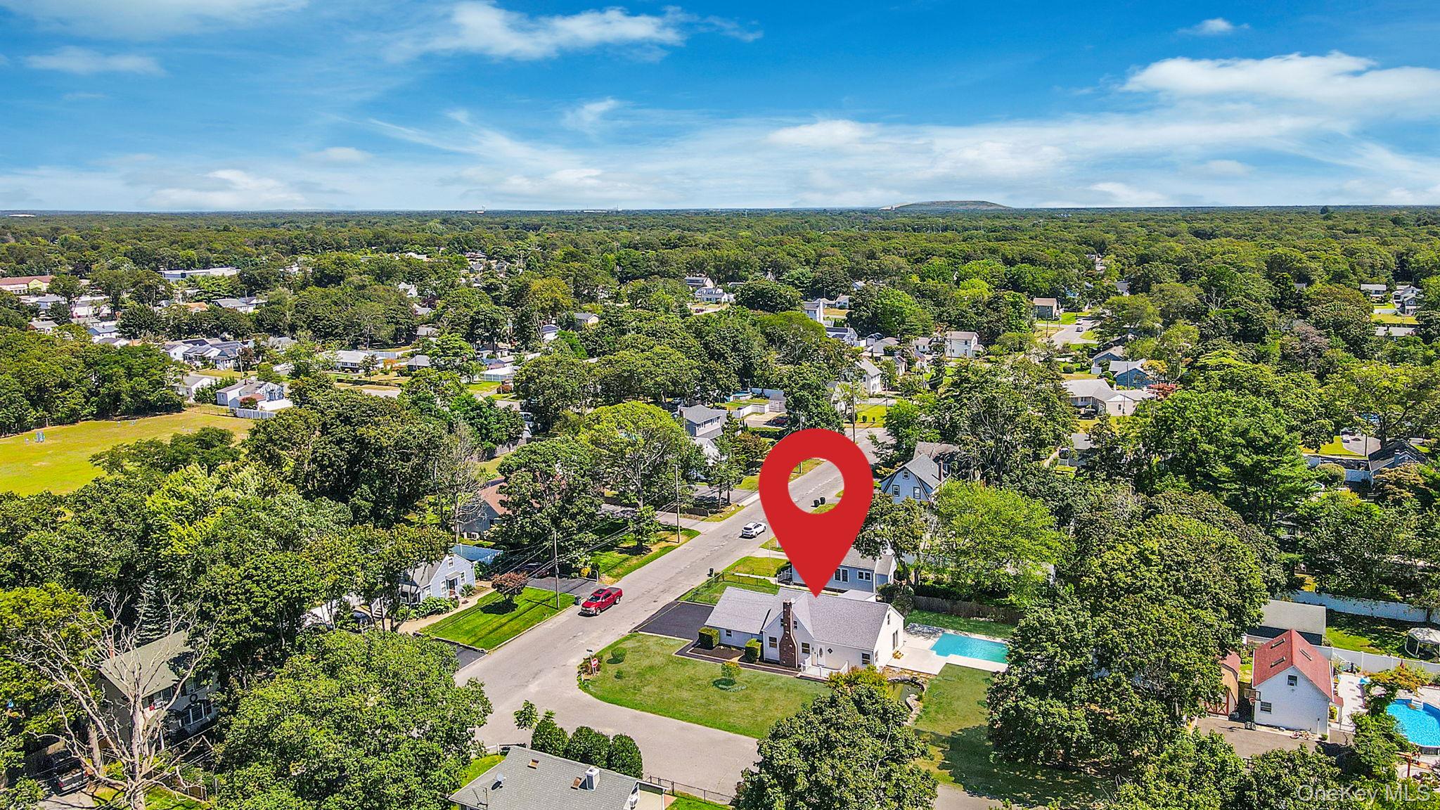 48 Vernon Street Patchogue, NY 11772 - Photo 30 of 31 Aerial perspective of suburban area featuring a pool