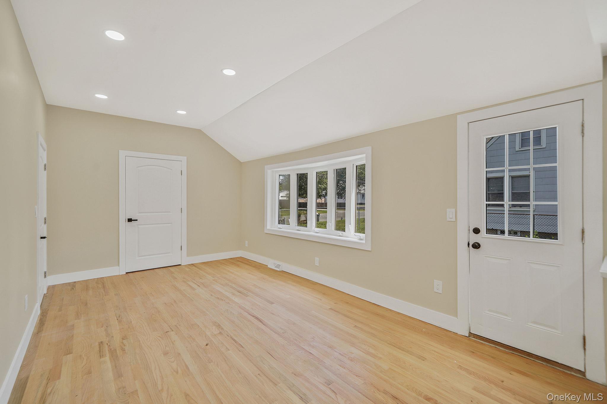 48 Vernon Street Patchogue, NY 11772 - Photo 10 of 31 Entrance foyer featuring recessed lighting, vaulted ceiling, and light wood finished floors