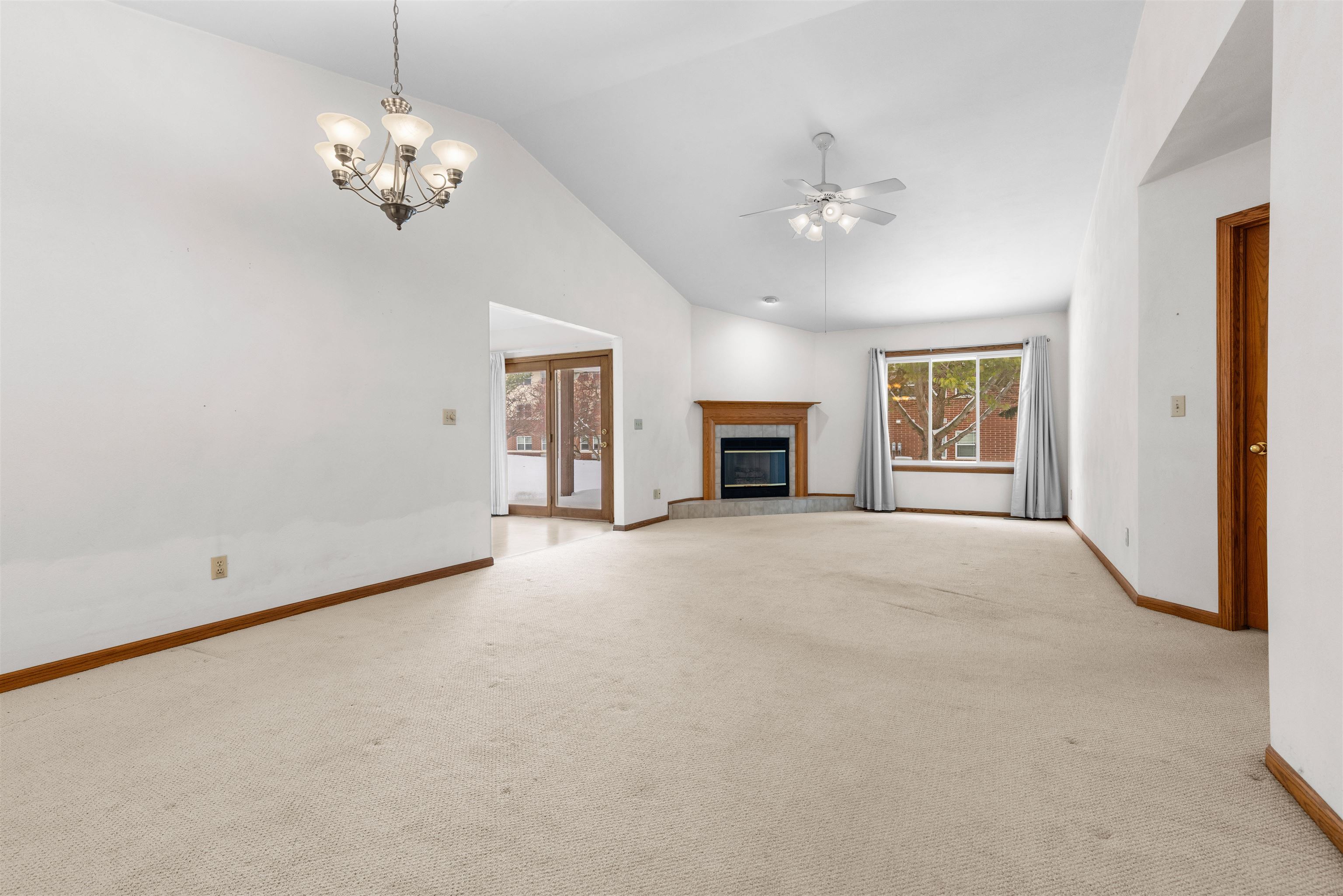 6644 North Point Road Rockford, IL 61108 - Photo 3 of 19 a view of empty room with a fireplace and chandelier fan