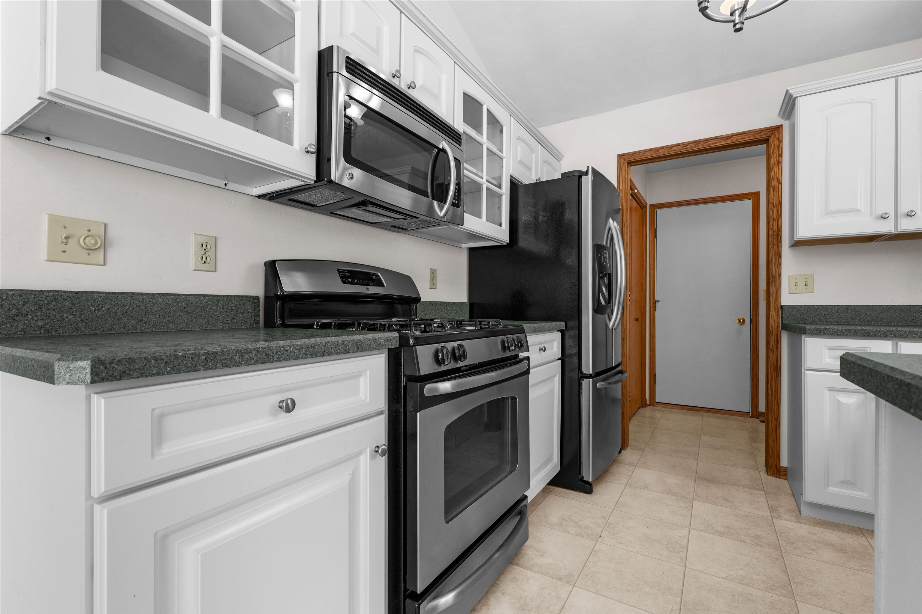 6644 North Point Road Rockford, IL 61108 - Photo 7 of 19 a kitchen with stainless steel appliances granite countertop a stove microwave and refrigerator
