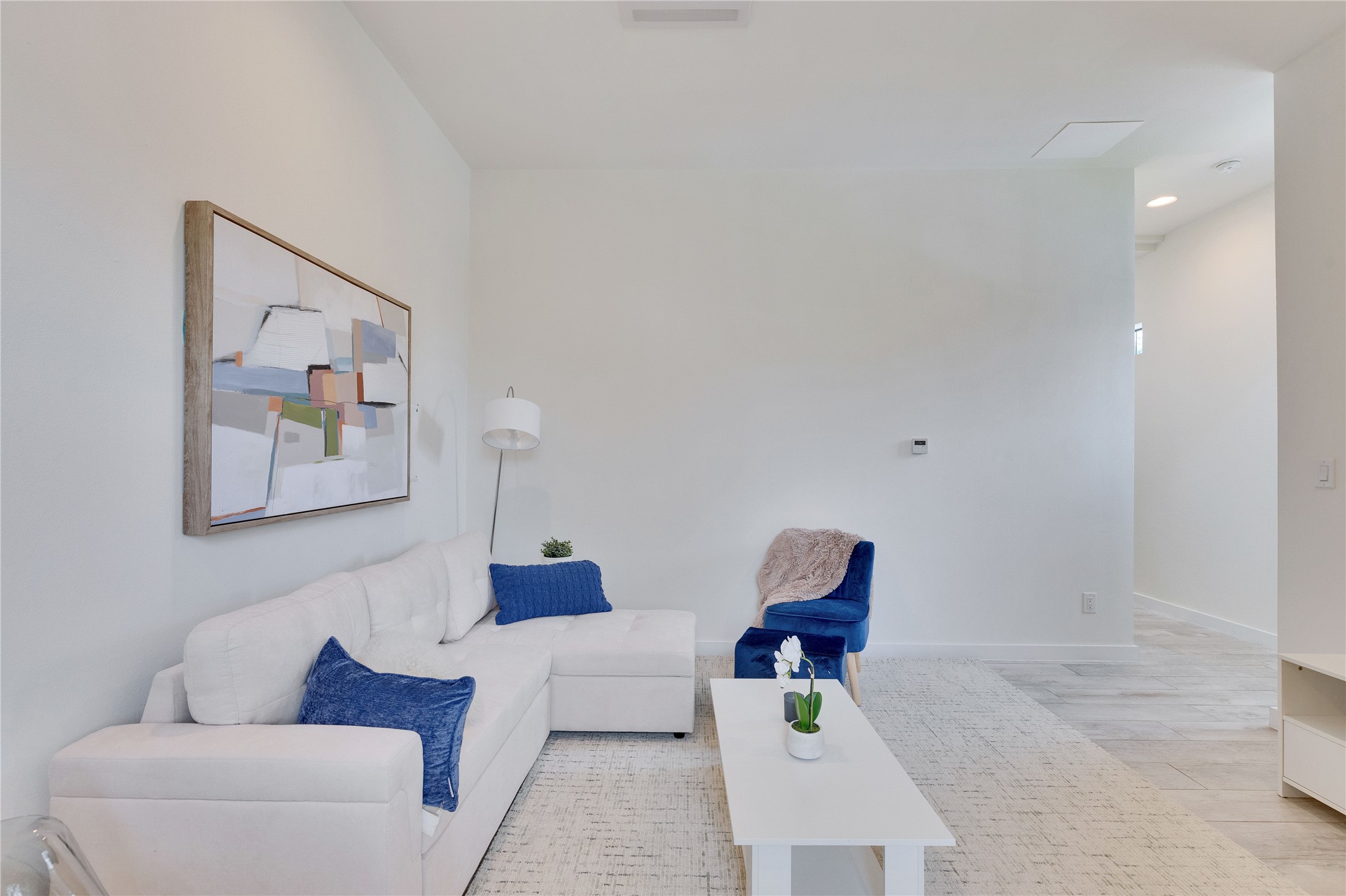 Living room featuring light wood-type flooring and recessed lighting