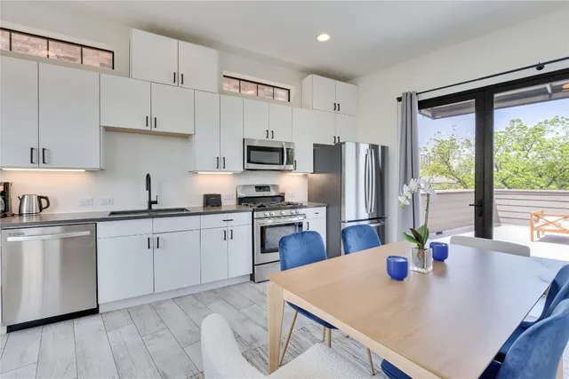 a kitchen with refrigerator cabinets and wooden floor