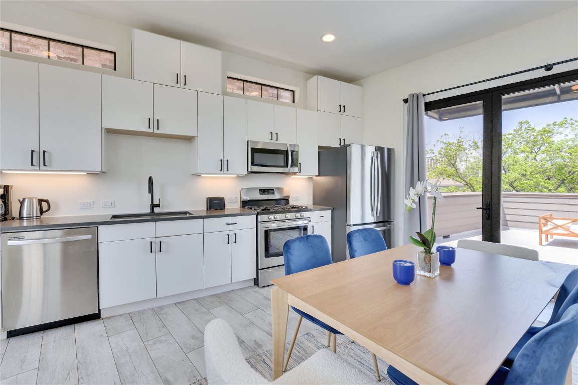 808 Lydia Street Austin, TX 78702 - Photo 17 of 40 a kitchen with refrigerator cabinets and wooden floor