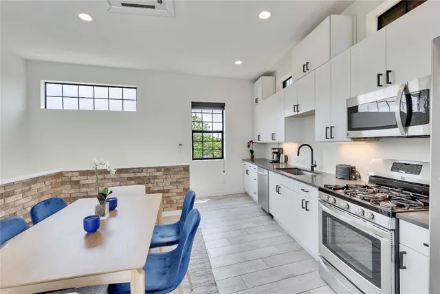 a kitchen with a stove a sink and a refrigerator