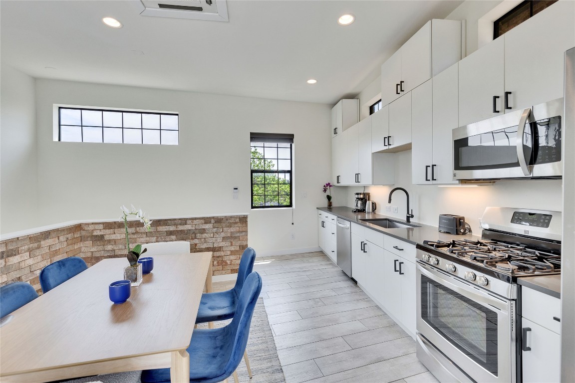 808 Lydia Street Austin, TX 78702 - Photo 20 of 40 a kitchen with a stove a sink and a refrigerator