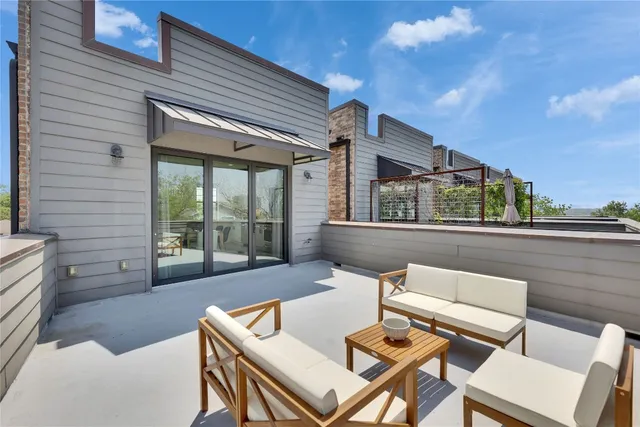 a kitchen with stainless steel appliances granite countertop a stove a sink dishwasher a refrigerator white cabinets and wooden floor next to a window